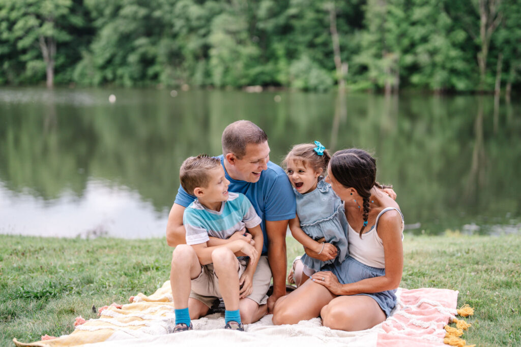 Family is happy and smiling during a lifestyle outdoor family photography session by Ivy Lulu Photography in Metrowest Massachusetts