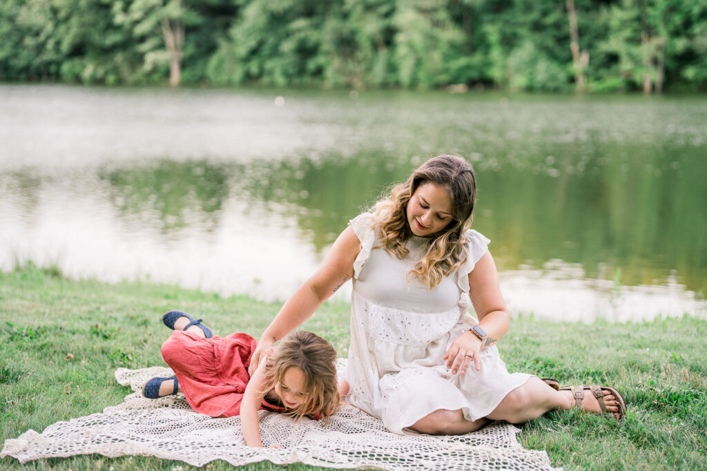Mom and little girl are playing in a lifestyle family photography session in Massachusetts