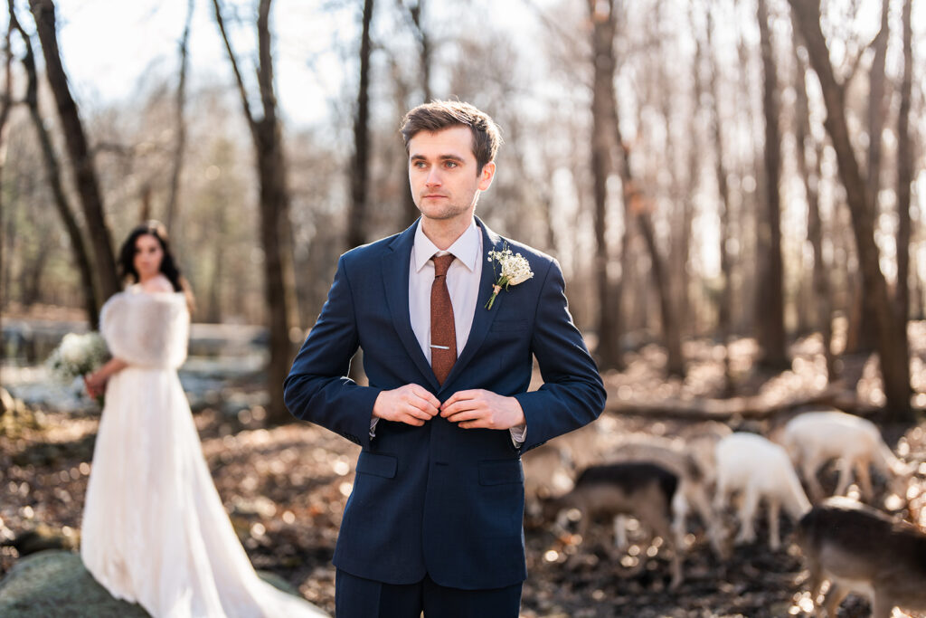 The groom is getting ready during an elopement wedding at Southwick's zoo.